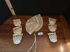 Vintage lace baby bonnet and 6 crochet high ball coasters (located in drawer in china cabinet)