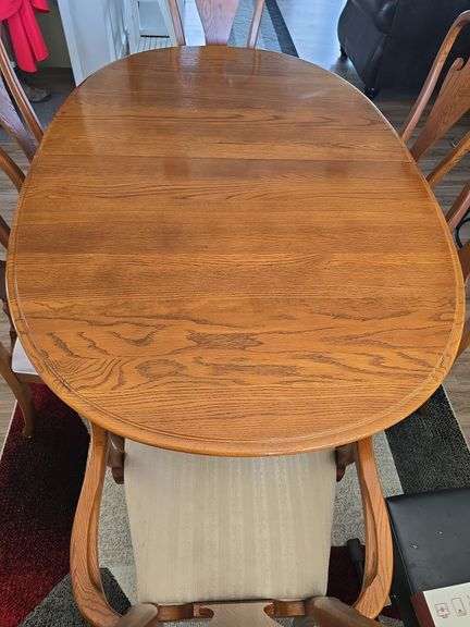 Oak oval table with 6 cushioned chairs approx 67" long