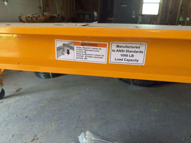 Yellow Scaffolding on casters with adjustable rack