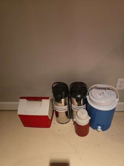 Assortment of thermoses, water jug, cooler