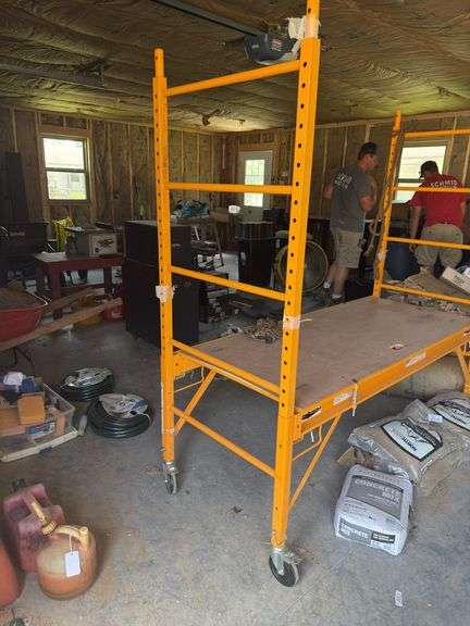 Yellow Scaffolding on casters with adjustable rack