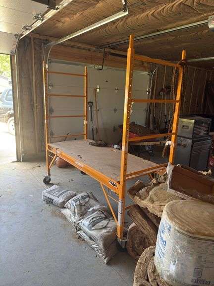 Yellow Scaffolding on casters with adjustable rack