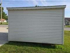 Portable shed 12'3"x10'3" 9' tall, 36"x80" door, on runners, buyers must remove