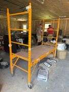 Yellow Scaffolding on casters with adjustable rack