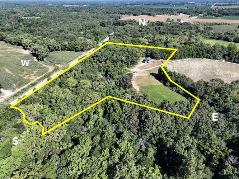 11.83 + or – Acres connected to Lake Nellie Property, 1,200 Sq. Ft. Home w/full walkout basement 9’ ceilings,  poured by Beccue Builders, open floor plan, 1 bed & full bath top level, oak cabinets, dishwasher, oven,  walk in pantry, covered deck top level w/lights, receptacles, and propane for grill, basement has fireproof concrete vault heavy duty safe door (can open from inside vault) 3 bedrooms in basement (1 is finished), unfinished bathroom in basement. Roof & Sides are Corrugated metal siding/cladding.