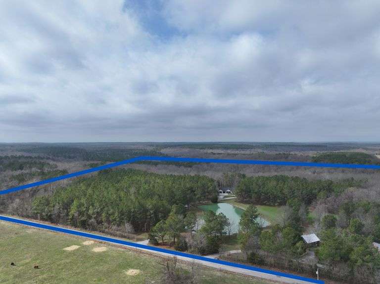 House: 1404 Sq. Ft. home with full walkout basement, built in 2022, pine cathedral ceilings, open floor plan, kitchen w/island bar, Hickory cabinets,  (kitchen is wired for dishwasher), 2 full bathrooms (1 is the master ensuite), 2 bedrooms on main level, Master bedroom walks out to deck, walk in closet, step in shower, utility room 2 washers & 2 dryers 3 years old, walkout deck w/awning installed 2025, above ground pool 3 year old liner, robot vacuum & new pump in 2025, 924 Sq. Ft. heated & cooled 2 car garage, basement was used for a yoga studio, bathroom w/walk in shower in basement, bedroom w/closet in basement, storage room in basement, shingled roof, 1 acre pond, approx 13ft deep in spots, w/sand beach 50ft into the water, beautiful trails for hiking, incredible hunting whitetail Deer & wild turkey, & camper spot w/electric. Entire acreage is all electric heat.  Parcel #11-1-18-144