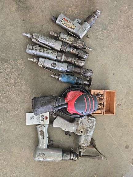 Assortment of air tools and electric sander.