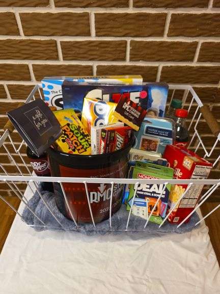 Basket includes $150 Washington Savings Bank Debit Card, $100 RMC Movie card, 2 board games, blanket, Instax camera, candy, and soda. Donated by: Washington Savings Bank