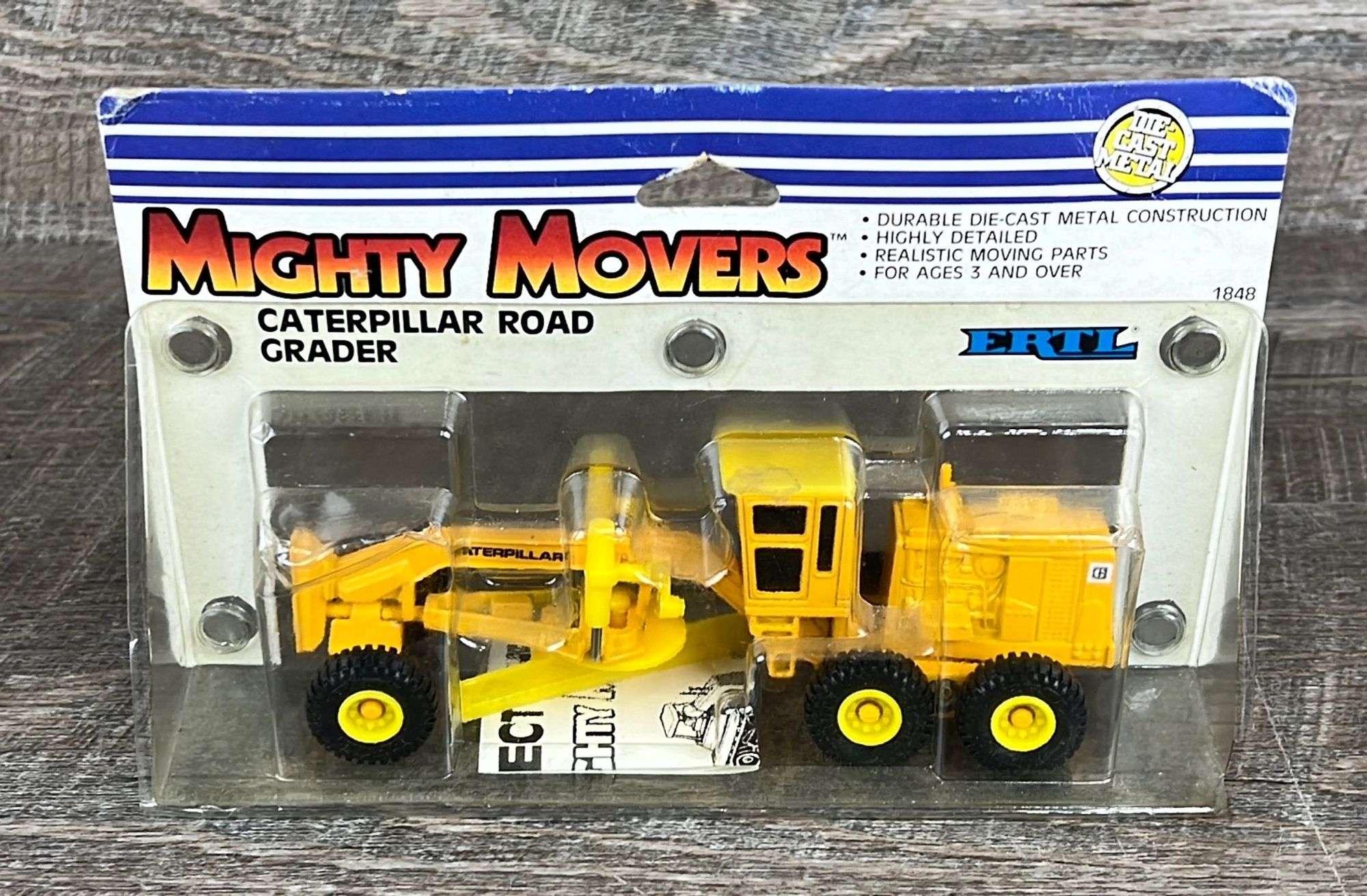 1/64 Ertl Mighty Movers die-cast Caterpillar road grader