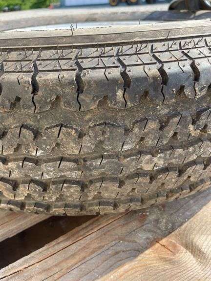2- trailer rims, 1 has tire