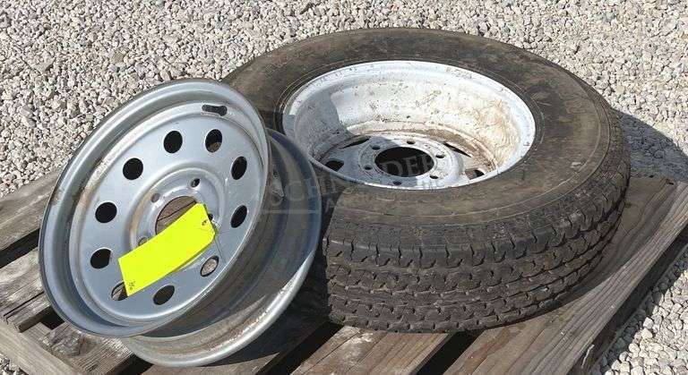 2- trailer rims, 1 has tire