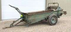 Ground drive manure spreader w/ steel floor
