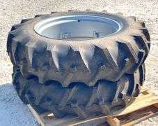 Pair of unused 12.4-28 tractor tires on unused rims