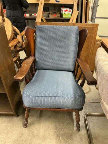 cushioned  chair with wooden armrest