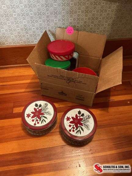 Glass vase with artificial flowers and a box full of tins ￼