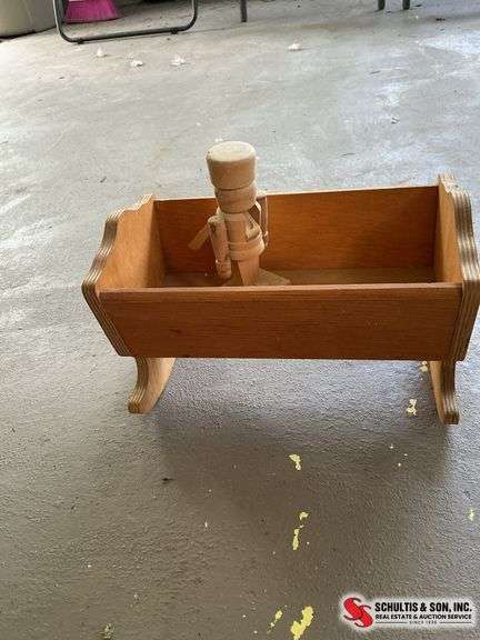 Small wooden nutcracker and small cradle