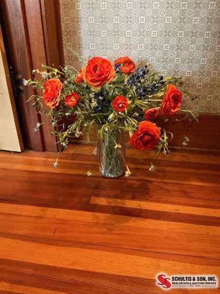 Glass vase with artificial flowers and a box full of tins ￼