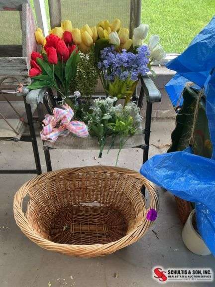Artificial flowers and wicker basket with small hole at the bottom