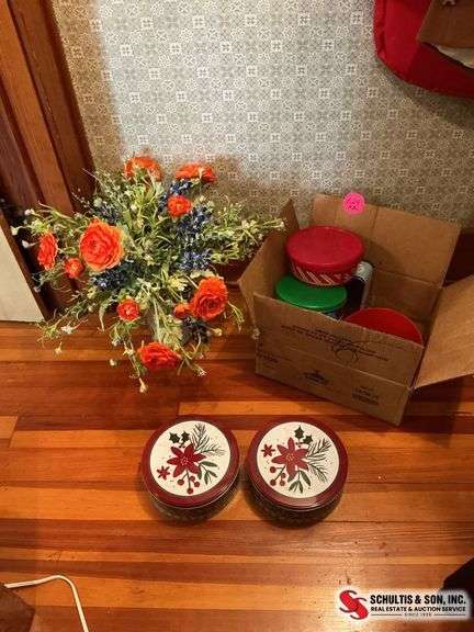 Glass vase with artificial flowers and a box full of tins ￼