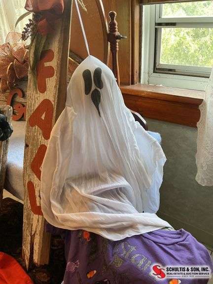 unique Halloween decor made out of wood and two Halloween t-shirts sizes, large and extra large ￼