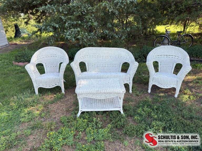 Four piece white wicker outdoor furniture set