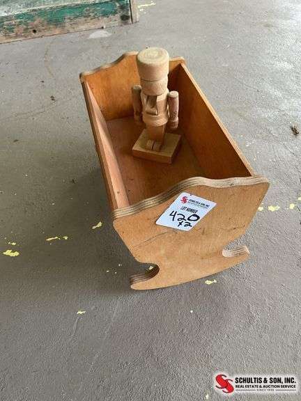 Small wooden nutcracker and small cradle