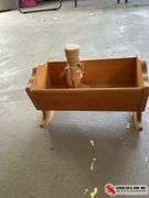 Small wooden nutcracker and small cradle