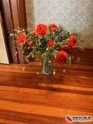 Glass vase with artificial flowers and a box full of tins ￼