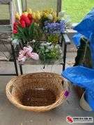 Artificial flowers and wicker basket with small hole at the bottom