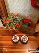 Glass vase with artificial flowers and a box full of tins ￼