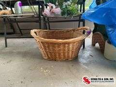 Artificial flowers and wicker basket with small hole at the bottom