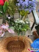 Artificial flowers and wicker basket with small hole at the bottom