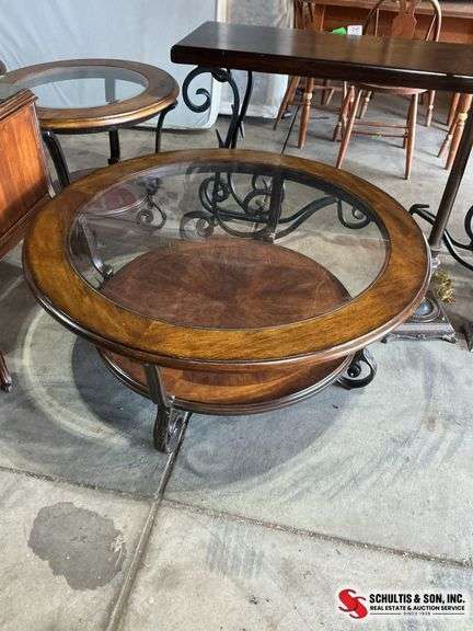 wood coffee table with a glass top and wrought iron legs 48” X 48” and the height is 19”