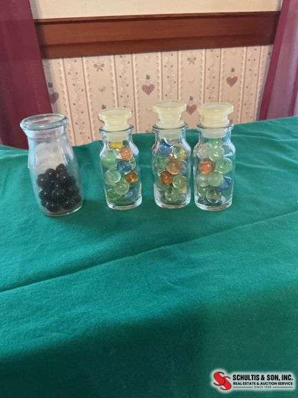Small glass bottles filled with colorful marbles