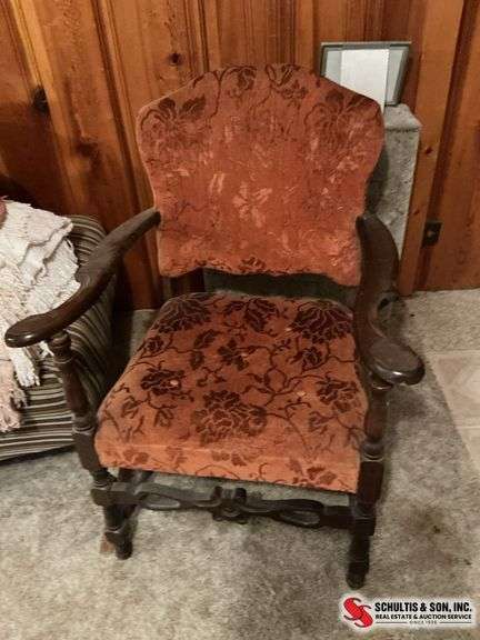 Antique padded chair with arms