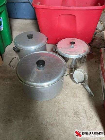 two aluminum and one stainless steel stock pots, and one aluminum ladle 