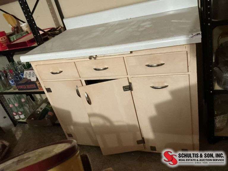 Old kitchen cabinet with flour ￼ bin in basement