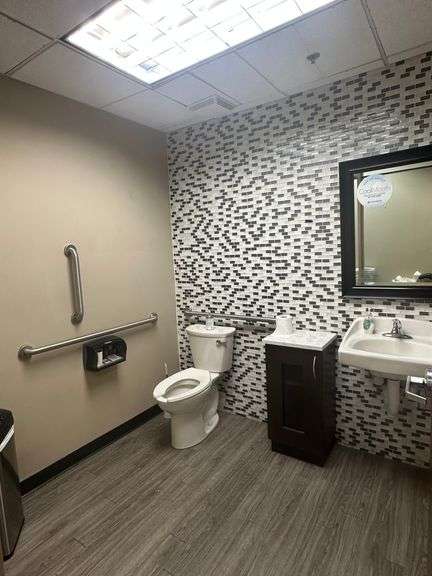 Contents of Bathroom including Square Cabinet, Mirror and Touchless Garbage Can