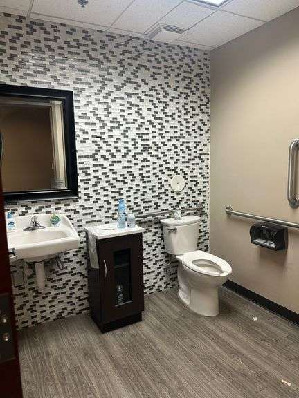 Contents of Bathroom including Square Cabinet , Mirror and Touchless Garbage Can