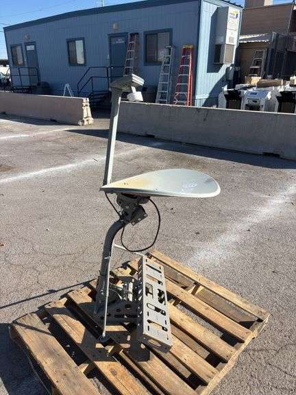 Dish  and antenna mast secured to a grey metal support bracket