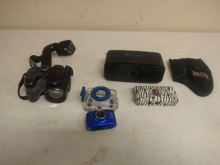 (1 Qty) Vivitar DVR 783HD, (1 Qty) GE Digital Camera X5, (1 Qty) Bluetooth Speaker, (1 Qty) Taser, (