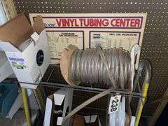 Vinyl Tubing rack with rolls of tube.