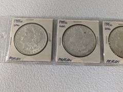 Lot of four 1885 O Morgan Silver Dollars