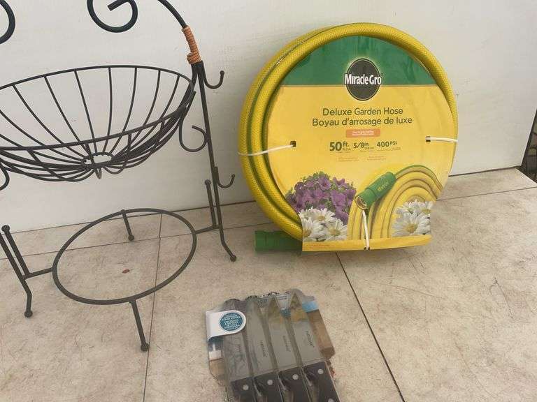 Unused 50' garden hose, ornamental iron plant stand, unused steak knives