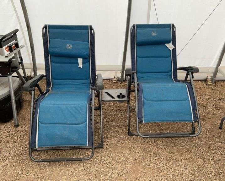 A pair of Zero-Gravity reclining lawn chairs