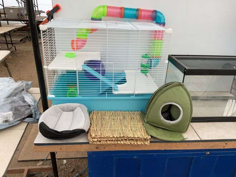 Hamster cage measures 23" long x 18" high x 13" wide, aquarium measures 20" long x 11" wide x 12" hi