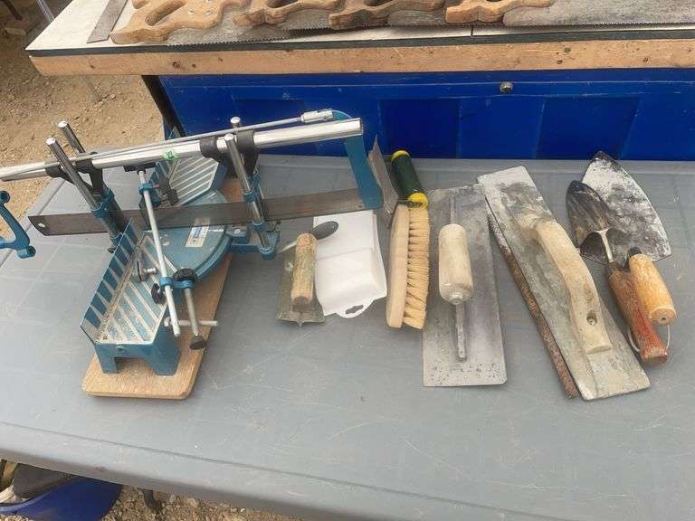 Post pounder, axe, quantity of hand saws, levels, hand mitre saw, trowels etc.