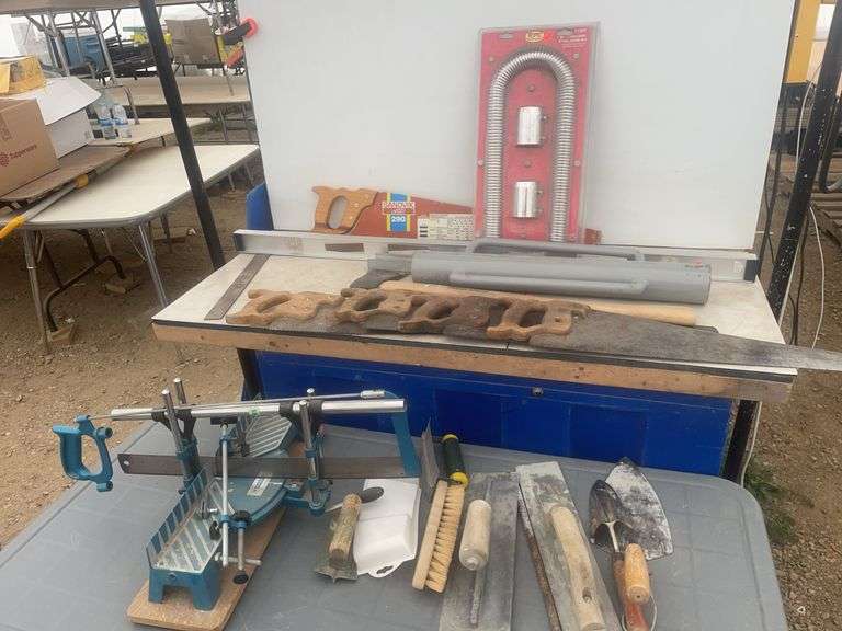 Post pounder, axe, quantity of hand saws, levels, hand mitre saw, trowels etc.