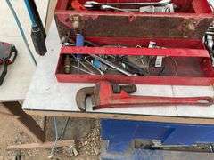 Toolbox comes with a quantity of miscellaneous tools including pipe wrench, crescent wrench, wheel w