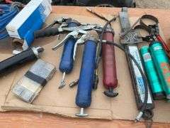 TOTE, several grease guns, grease, cork  gasket material, friction sway bar, booster cables, filter 